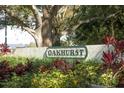 Oakhurst community sign surrounded by lush landscaping and foliage at 4131 Oakhurst W Cir # 3133, Sarasota, FL 34233