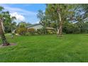 Lush green lawn and mature landscaping surround this well-maintained home exterior at 4637 Willow Wood Cir # 44, Sarasota, FL 34241