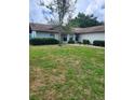 Inviting front yard with lush green grass and manicured bushes enhances curb appeal at 5213 20Th Street E Ct, Bradenton, FL 34203