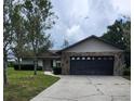Charming single-story house with a stone-accented garage and well-kept landscaping at 5213 20Th Street E Ct, Bradenton, FL 34203