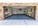 Large garage interior with built-in shelving, providing ample storage and workspace at 5213 20Th Street E Ct, Bradenton, FL 34203