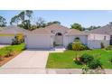 Well-kept home with a two-car garage, landscaped front yard, and a welcoming entrance at 5410 Matthew Ct, Sarasota, FL 34231
