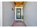 Welcoming front entry showcasing a decorative wreath, brick flooring, and a charming welcome mat at 5515 69Th E Pl, Ellenton, FL 34222