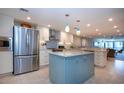 Bright kitchen with stainless steel appliances, island, and pendant lights at 5750 Midnight Pass Rd # 203, Sarasota, FL 34242