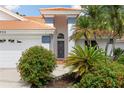Close-up of the front door featuring lush landscaping and a well-maintained entrance at 6755 Approach Rd # 31, Sarasota, FL 34238