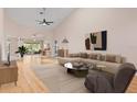Bright living room boasting high ceilings, hardwood floors, and stylish modern furniture at 6755 Approach Rd # 31, Sarasota, FL 34238