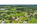 A large parcel of land is ready for development surrounded by lush greenery, homes, and a serene pond at 6875 Myakka Valley Trl, Sarasota, FL 34241