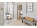 Inviting foyer with neutral walls, tiled floors, a comfortable bench, and decorative accents at 7343 Birds Eye Ter, Bradenton, FL 34203