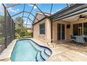 Screened-in pool area with a refreshing pool, tile patio, and outdoor dining space, perfect for relaxation at 7343 Birds Eye Ter, Bradenton, FL 34203