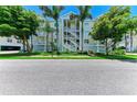 A well maintained condo building with a charming exterior, featuring a central staircase and lush landscaping at 7820 34Th W Ave # 102, Bradenton, FL 34209