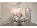 Elegant dining room with a modern chandelier and seating for four, perfect for intimate gatherings at 8557 Milestone Dr, Sarasota, FL 34238
