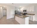 Well-lit kitchen features stainless steel appliances, granite countertops, and white cabinetry at 8557 Milestone Dr, Sarasota, FL 34238