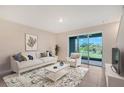 Bright living room featuring a sliding glass door and neutral decor, creating a relaxing atmosphere at 8557 Milestone Dr, Sarasota, FL 34238