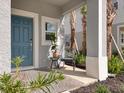 Inviting covered front porch with a chair, small table, and view of the landscaped yard at 8733 Winter Breeze Way, Sarasota, FL 34241