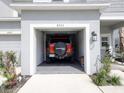 Attached one car garage featuring an automatic door and ample storage space at 8733 Winter Breeze Way, Sarasota, FL 34241