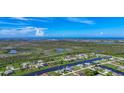 Scenic aerial view of a residential community surrounded by waterways and lush green spaces with a coastal backdrop at 1167 Boundary Blvd, Rotonda West, FL 33947