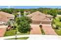 Aerial view of the property with a manicured lawn and a tile roof at 1375 Backspin Dr, Englewood, FL 34223