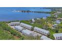 Panoramic aerial view of multi-Gathering homes with scenic waterfront and lush greenery at 1500 Sunset Rd # B4, Tarpon Springs, FL 34689