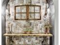 Charming entryway featuring textured wall with decorative table and stylish sconces at 19351 Ranchview Ct, Land O Lakes, FL 34638
