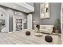 Elegant living room featuring high ceilings, stylish decor, and light wood flooring at 19351 Ranchview Ct, Land O Lakes, FL 34638