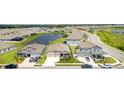 Wide aerial shot capturing the residential neighborhood, complete with a pond and well-maintained lawns at 2108 Citrus Breeze Dr, Bradenton, FL 34208