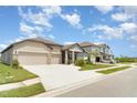A residential street view showcases houses with well-kept lawns and landscaping, and spacious driveways at 2108 Citrus Breeze Dr, Bradenton, FL 34208
