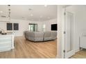 Bright open-concept living space with light hardwood floors, contemporary decor, and lots of natural light at 2108 Citrus Breeze Dr, Bradenton, FL 34208