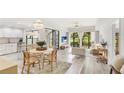 Bright living room with an open floor plan, seamlessly connecting the dining area and a view of the green outdoors at 2383 Lakeside Mews # D3, Sarasota, FL 34235