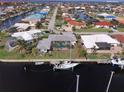 Expansive aerial view of the waterfront property, showcasing the pool, private dock, and canal access at 2807 Coral Way, Punta Gorda, FL 33950
