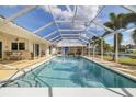 Inviting screened-in pool with clear blue water, surrounded by ample deck space for lounging and enjoying outdoor living at 2807 Coral Way, Punta Gorda, FL 33950