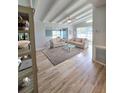 Bright living room featuring wood floors, vaulted ceilings, and comfortable seating at 3727 Dover Dr, Sarasota, FL 34235