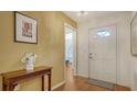 Welcoming foyer with hardwood floors, a console table, and a bright front door at 4198 Vallarta Ct # 3027, Sarasota, FL 34233