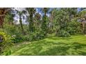 An expansive backyard featuring lush greenery and natural vegetation, perfect for outdoor enjoyment at 4511 Windsor Park, Sarasota, FL 34235