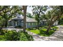 Charming single-story home featuring mature landscaping, a concrete driveway, and a serene setting at 4511 Windsor Park, Sarasota, FL 34235