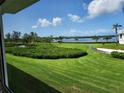 Beautiful view of the green space and water from the back of the property at 4832 Independence Dr, Bradenton, FL 34210