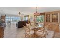 Inviting dining area featuring a glass table and stylish chandelier open to the living room at 4832 Independence Dr, Bradenton, FL 34210