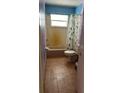 Bathroom with toilet, shower, and window at 4959 Habana Dr, Sarasota, FL 34235