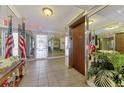 Well-maintained lobby featuring mirrored walls, tile flooring, and secure elevator access at 519 Albee Farm Rd # 212, Venice, FL 34285