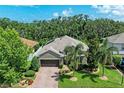 Stunning aerial view of a single-Gathering home with a brick driveway, mature trees, and lush landscaping at 5307 65Th E Ter, Ellenton, FL 34222