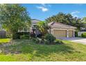 Charming single-story home with a well-maintained lawn and a three-car garage at 5401 Oak Grove Ct, Sarasota, FL 34233