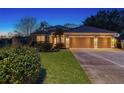 Well-maintained home with a three-car garage, lush landscaping, and inviting curb appeal at 5401 Oak Grove Ct, Sarasota, FL 34233
