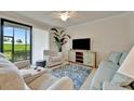 Relaxing living room featuring comfortable seating, stylish decor, and a serene view of the golf course at 5528 Palmer Cir # 104, Bradenton, FL 34211