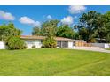 Well-kept single Gathering home with a green lawn, driveway and mature landscaping at 5948 Mirror Lake Rd, Sarasota, FL 34238