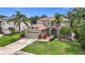 Beautifully landscaped front yard and exterior of a two-story home with an attached garage at 6043 44Th E Ct, Bradenton, FL 34203