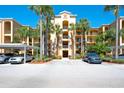 Condo complex with lush tropical landscaping and covered parking, offering a serene and convenient living environment at 6509 Grand Estuary Trl # 201, Bradenton, FL 34212