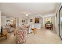 Open-concept living area with tile flooring, neutral walls, and multiple seating and dining areas at 6923 Grand Estuary Trl # 101, Bradenton, FL 34212