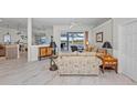 Light-filled living room features neutral paint, tile flooring, and sliding glass doors offering serene outdoor views at 8106 Arlewood Cir, Port Charlotte, FL 33981