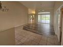 Open-concept living area with a combination of tile and wood flooring and sliding glass doors at 9926 Gulfstream Blvd, Englewood, FL 34224