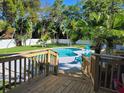Inviting backyard pool area with a wooden deck, clear blue water, and comfortable lounge chairs at 1112 Montezuma Dr, Bradenton, FL 34209