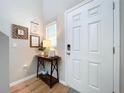 Entryway features a stylish console table with decor, a welcoming atmosphere, and a secure electronic door lock at 12832 Oak Hill Way, Parrish, FL 34219